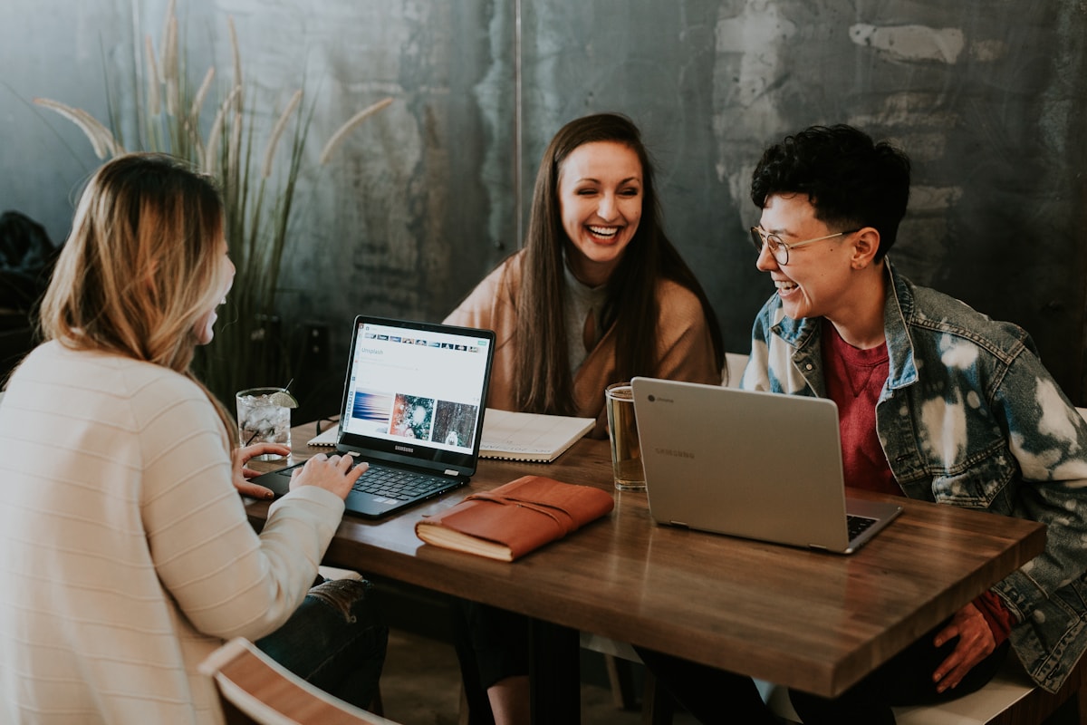 Creators collaborating around laptops on a social media project