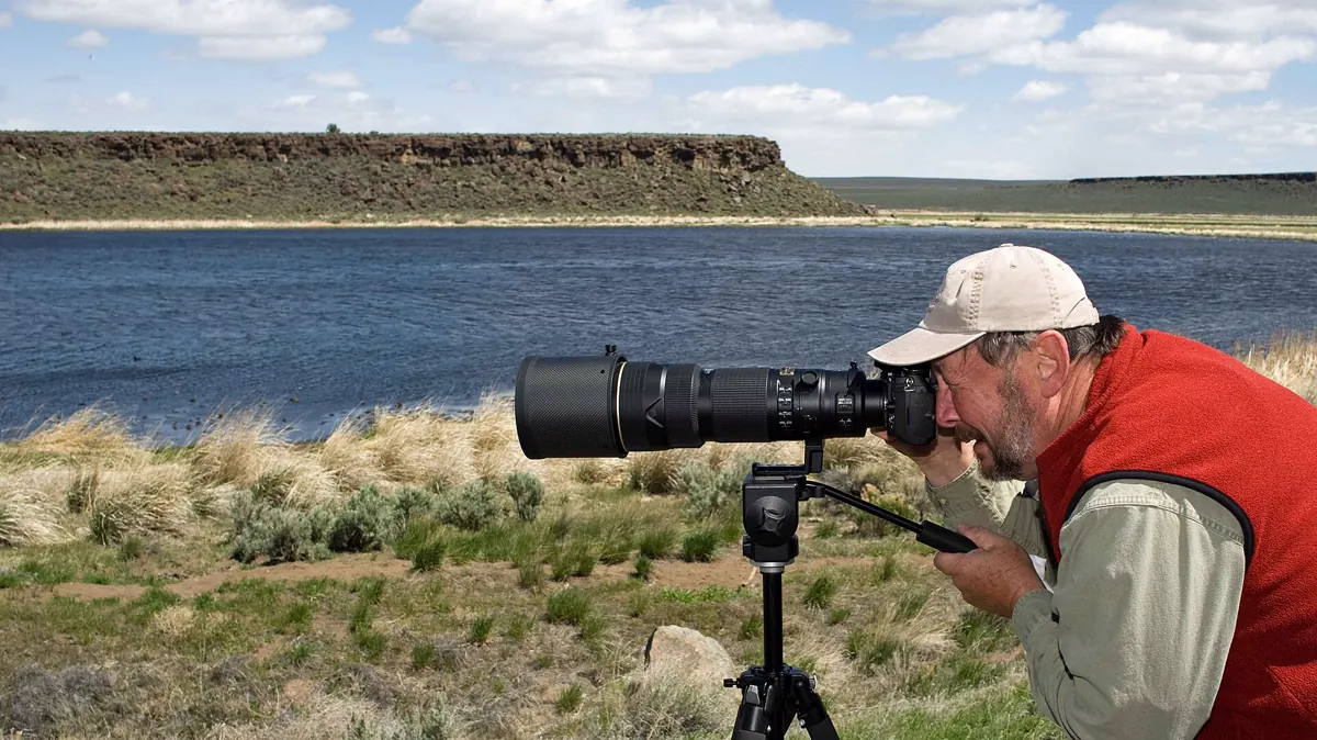 A photographer using a professional camera to capture high-quality media